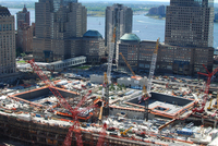 Cranes surround the future site of two giant man-­made pools.