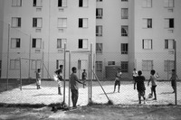 Photograph of teenagers playing soccer in the project’s common courtyard.