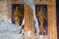 Photograph of a detail of one of the faux doors of Villa A Oplontis with images of Nike/Victoria.