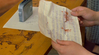 a letter with blood stains on it, from deceased person