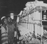 Fig04_01. A line of textile mill workers with spindles producing thread for weaving.
