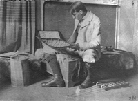 Edwin Tappan Adney, the expert on bark canoes, studies one of his models in 1896.