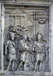Relief panel from the Arch of Constantine showing the safe return of the emperor (originally Marcus Aurelius) in chariot in front of a Corinthian-style temple, whose pediment is decorated with the characteristic attributes of Fortuna Redux, and approaching a tetrapylon arch monument surmounted by elephant quadriga through which he will pass to enter the city.