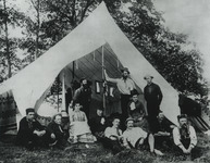 The St. Lawrence Canoe Club tent at the ACA meeting on Grindstone Island in 1886. J. H. Rushton is the short, bearded man standing in the center; his wife Leah is seated next to him.