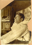 Photograph of Meyerhold, in profile, eyes gazing upward, in the white costume of Pierrot.