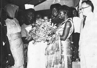 Fig. 1: Photograph of Anna Foncha receiving flowers from local women in West Cameroon, ca. 1960s.