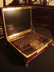 Photograph of steampunk-­style laptop, encased in dark wood and with brass ornamentation added.