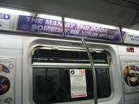 A photo of an advertisement on a New York City subway train that says in capital purple letters "The man by the door will someday be your boss." Beneath those words is the website "u-r-connected.com."