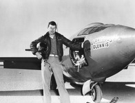Fig. 5. Test pilot Chuck Yeager in flight gear, helmet under his arm, standing next to the X-1 rocket plane.