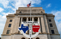 A U.S. federal building that sits astride the border between the states of Arkansas and Texas, with courthouses serving the two states on each side and a shared post office.