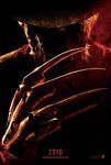 A film poster for the 2010 remake of the film Nightmare on Elm Street, with a close-up of the ominous character Freddy Krueger, reflecting firelight with a large claw-like metal hand with knives for fingers. The numbers "2010" and the website "www.nightmareonelmstreet.com" appear in red at the bottom of the poster.