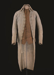 Photograph of an eighteenth-century gentleman’s coat in the Colonial Williamsburg Museum collection. The coat is a pale, off-white colour and is made of cotton and wool with wooden buttons covered with fabric.