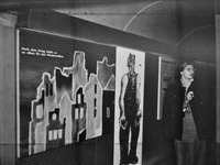 A graphic of a bombed-out cityscape next to a life-size drawing of a man in shabby clothes with outstretched hands. A well-dressed female visitor looks away.