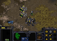 Three Terran buildings (one Barracks and two Supply Depots) placed closed to each other to block a narrow passage.