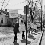 John Lewis (left), Archie E. Allen, and other students representing the Nashville Christian Leadership Council protest on Jefferson Street in Nashville during the Freedom March, March 23, 1963.