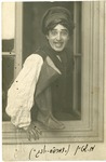 Black-and-white photograph of actor Alex Stein climbing out of a window.