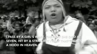 Black and white music video shows Queen Latifah in the foreground. A large crowd dances behind her.