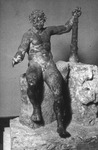 Bronze statuette of Hercules wearing wine leaves on his head but otherwise nude; he sits on a rock, balancing himself with his club, holding a cup in his right hand (now missing) as if feasting at a table; found in the garden of a villa near Pompeii. Its name “epitrapezios” has been interpreted either as “table statuette” or “banqueting.”