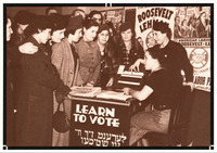 Two women at a table with the sign “Learn to Vote” in Yiddish and English. A crowd of women dressed in coats, hats, and gloves looks on and listens. American Labor Party signs on the wall.