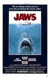 A film poster for the film Jaws, with the words "JAWS" in large red letters at the top and a young woman swimming across the ocean beneath the letters. A large, great white shark, jaws open, comes up at her from below with the caption "The terrifying motion picture from the terrifying No. 1 best seller." The poster lists the actors in the film, including Roy Scheider, Robert Shaw, and Richard Dreyfuss.
