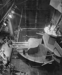 Photograph depicting bird’s-­eye view of large gunboat set piece and water-filled stage in New York Theatre Guild production.