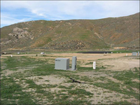 Photo of the Stringfellow Superfund site with vegetation growing after removal of the acid pits