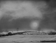 A convoy on a dirt road in the snow.