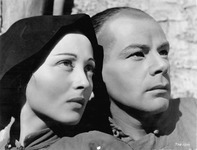 Photograph of the faces of Luise Rainer and Paul Muni wearing makeup and costumes