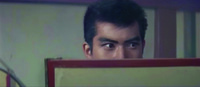 Close-­up on Katsuta, just Right of center, as he looks sharply off-­screen Right. The frame is bisected by the red-­painted top frame of the folding screen, foreground and just below center, blocking the lower half of Katsuta’s face from view.