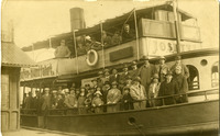 Black-and-white photograph of actors on the deck of a ship. 