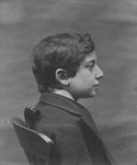 Portrait of a Jewish boy seated on a chair with a rod behind his back to standardize body angles for Galton’s composite of the Jewish type.