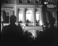 Adenauer (center, in the second-floor window) is honored with a Grand Tattoo ceremony in the courtyard of the Federal Chancellery on his eighty-fifth birthday.