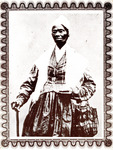 Truth wears a long, full skirt, a long-sleeved jacket, and a white shawl. A cloth bag is draped over one arm. She holds a cane in her other hand. She wears her signature white cap and spectacles.
