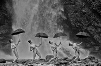 Figure 14.2. Four women, nearly naked, hold black umbrellas high overhead. They walk in a row, bending backwards, along the edge of a waterfall.