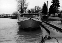 A photograph of the front of a fisherman's boat sitting at the dock.