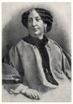 Elegant waist-up photo of Sand in a smock-like jacket with full sleeves. She has wavy, mid-length hair and dangling earrings.