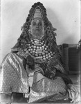 Black and white photo taken by Yahiya Haiby of his sister, Miriam seated and dressed as a traditional Yemeni bride for her wedding ceremony.