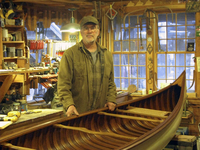 Tom Seavey with a 1905 Morris Veazie canoe that he restored.