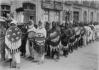 Caballeros tigres, wearing jaguar body suits and carrying decorated shields.