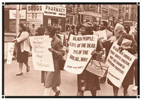 Demonstration on a busy street. Stores and bystanders in the background. Women wearing hats or scarves carry signs saying “BOSTON Welfare Mothers Oppose War in Vietnam.”