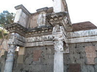 View of the surviving stretch of the lateral wall of the Forum Transitorium. A pair of Corinthian columns supporting a projecting entablature and attic. In the attic is a helmeted figure traditionally identified as Minerva, Domitian’s patron goddess.