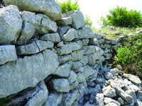 Wall made of large stones at Vorfë photographed at an angle.
