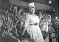 A black and white photograph of  Toña la Negra wearing Caribbean-­style dress on stage with Son Clave de Oro in the role of Marta the Mulata in the film Konga roja.