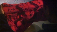 A red cloth from a wedding at the beginning of the film is covered with calligraphy written by party guests.